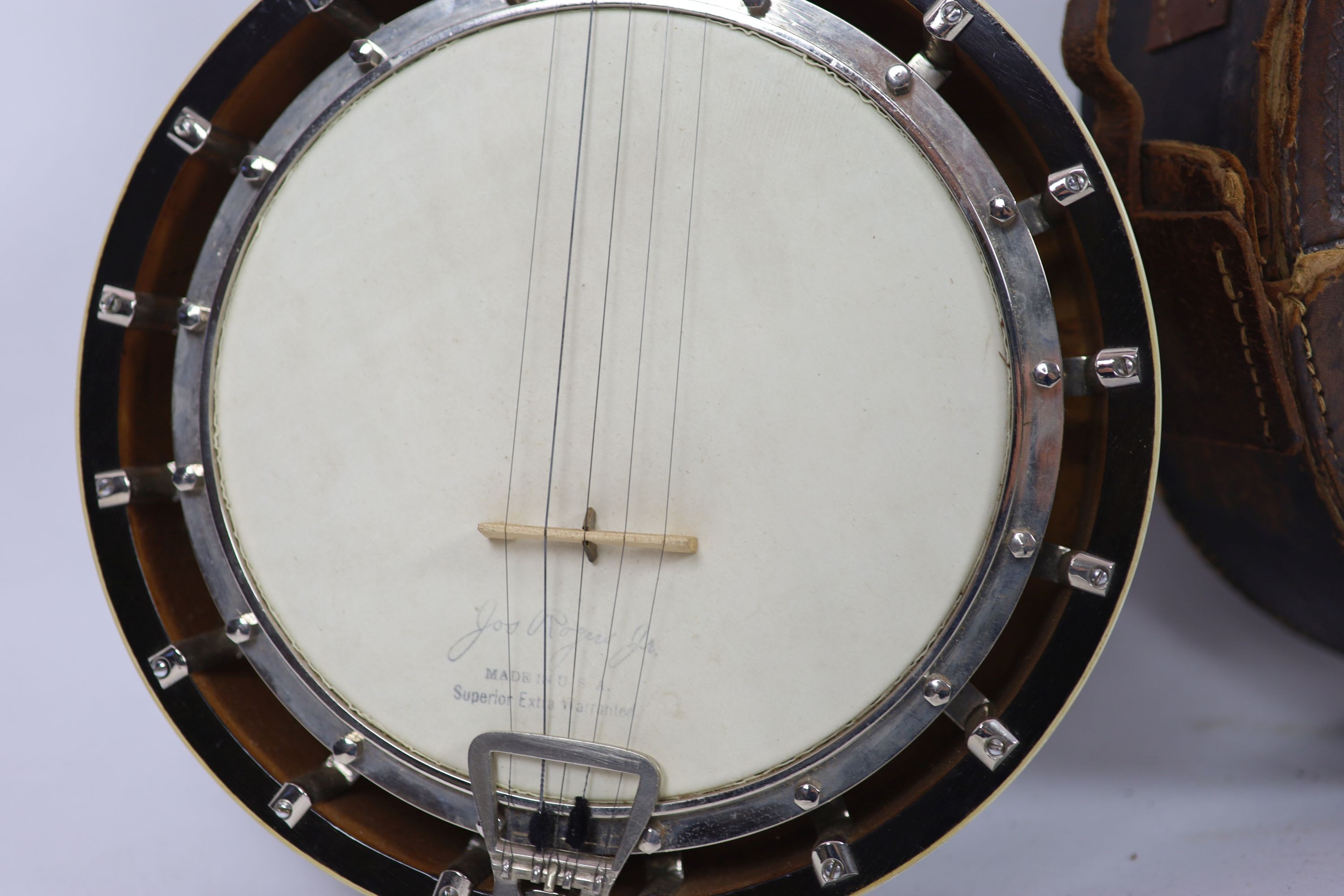 A Clifford Essex ebony mounted banjo, length 94cm, with distressed leather case